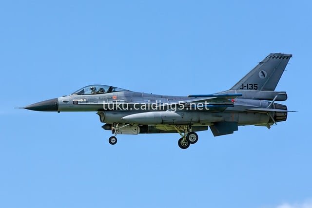 F-16 Fighter Jet in Flight: Military Aircraft Soaring in the Blue Sky