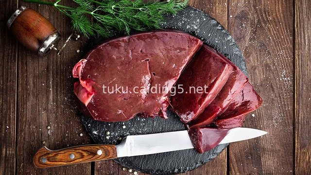 Close-up of Fresh Raw Liver Slices on Black Slate