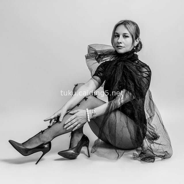 Elegant Posing of Fashion Model in Tulle Outfit, Fishnet Stockings and High Heels