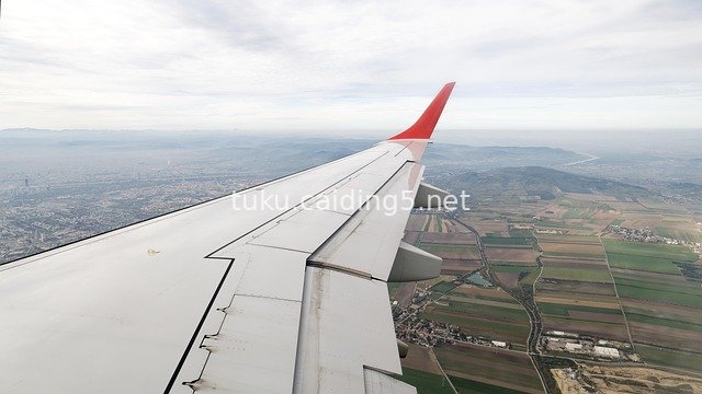 Aerial Shot of City & Rural Scenery with Airplane Wing