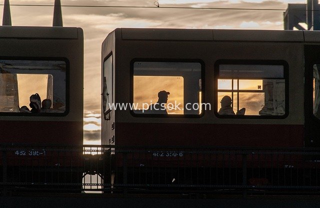 Silhouetted City Trains at Dusk: Sunset Transportation Landscape