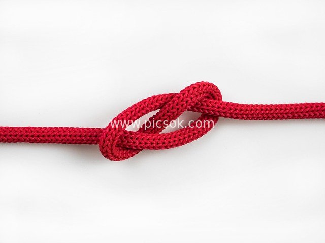 Close-up of Red Braided Knot | Handwoven Interlaced Detail Stock Image
