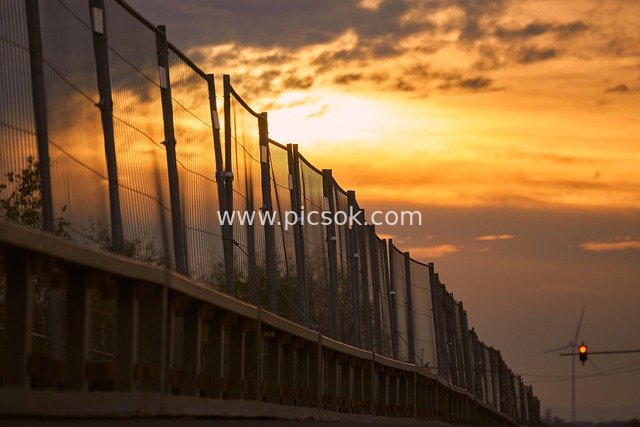 Bridge Construction Fencing and Traffic Lights at Sunset
