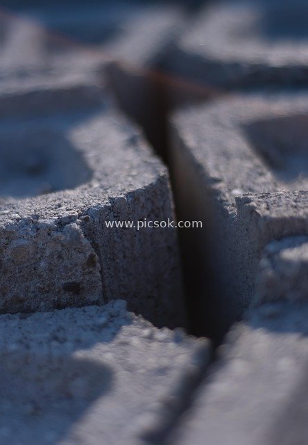 Close-up of Gray Concrete Bricks: Geometric Texture, Shadow, and Textural Elements