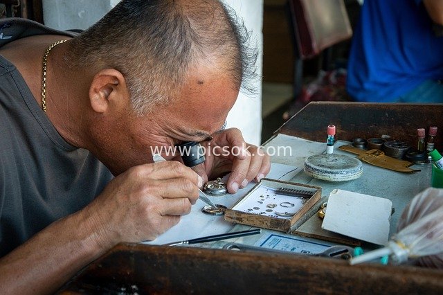 Watchmaker Focused on Handcrafted Clock Repair – Artisan at Work in Studio