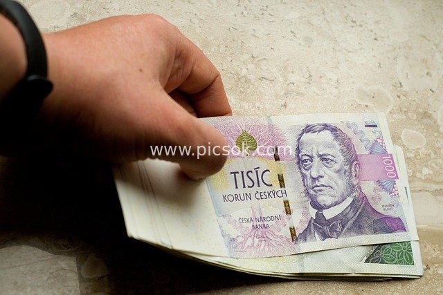 Hand Holding Czech Koruna Cash Banknotes | Financial Scene with Marble Background