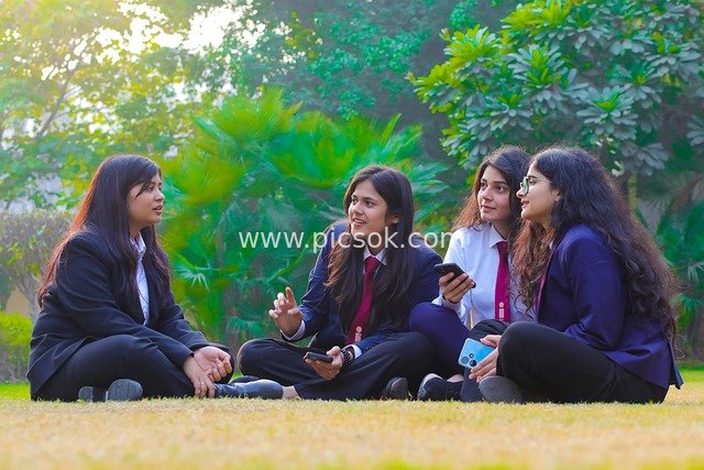 Female College Students Chatting on Outdoor Lawn—Youthful Campus Gathering of Friends