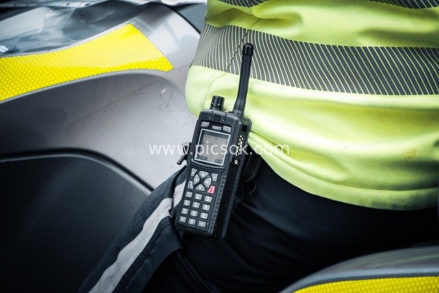 Close-Up of Police on Duty: Fluorescent Uniform and Professional Walkie-Talkie