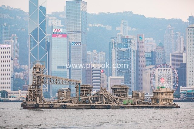 Industrial Vessel and Financial District Skyline in Hong Kong Victoria Harbour