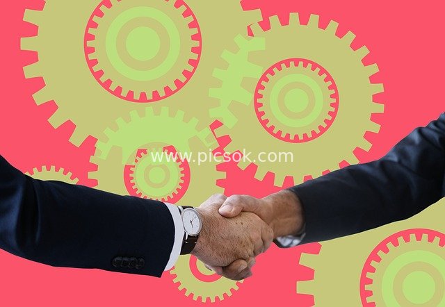 Business Professionals Shaking Hands for Collaboration – Workplace Scene with Gear Background