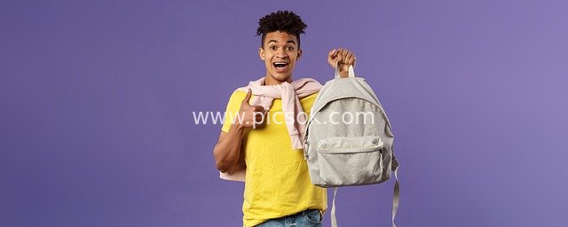 Vibrant Young Man Smiling with Backpack – Portrait of a Youthful Student