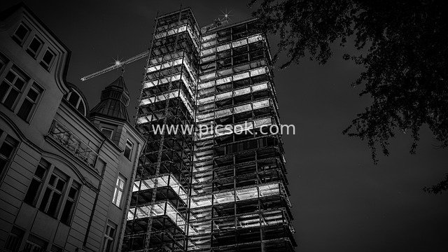 Night-lit Skyscraper Construction Site with Cranes