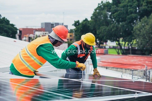 Solar Panel Installation Workers in Action - Green Ecological Energy Project