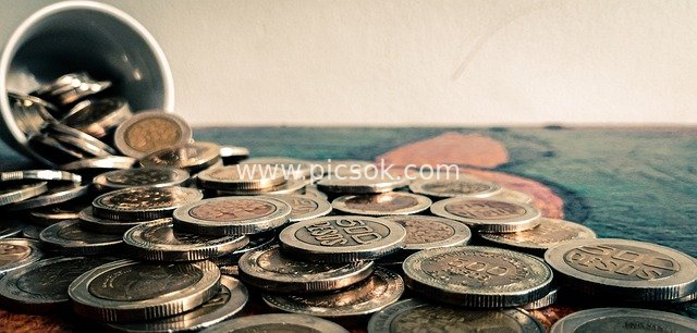Scattered Colombian Peso Coins - Financial Savings and Investment Material