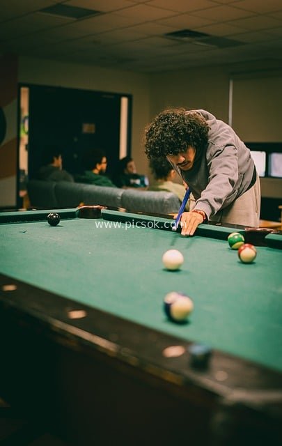 Competitive American Eight-Ball Pool Moment in College Game Room