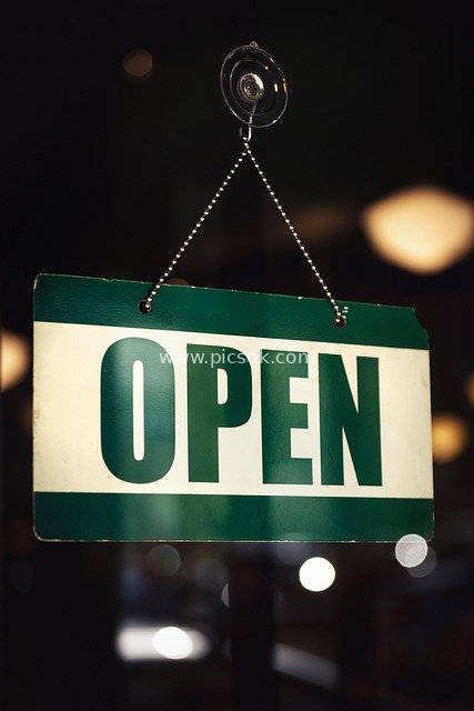 Green OPEN Business Sign Hanging in Shop Window