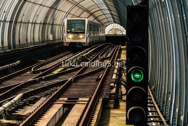 Train Approaching in Subway Tunnel with Green Signal Light