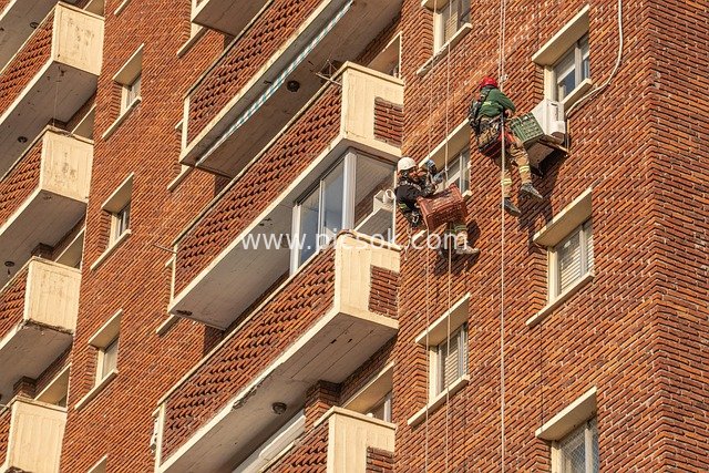 High-Altitude Workers Performing Exterior Wall Work - Real Footage of Rope-Assisted Construction