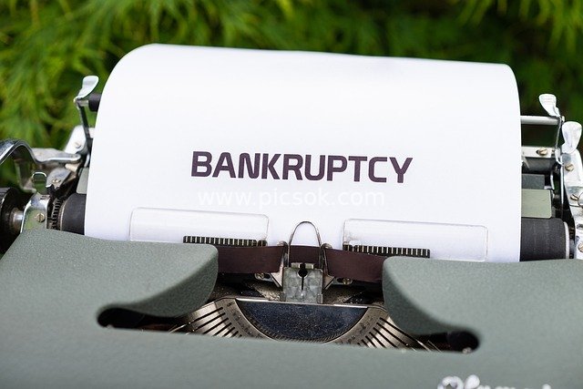 Vintage Typewriter Printing 'Bankruptcy' - Economic Crisis Warning Image