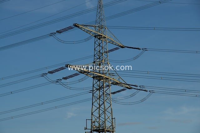 High-voltage Transmission Tower and Lines Against a Blue Sky