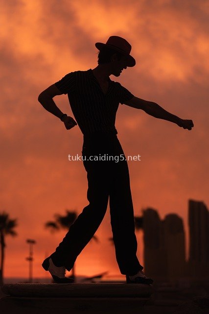 Silhouette of a Red-Hat Dancer Performing Artistic Dance at Sunset