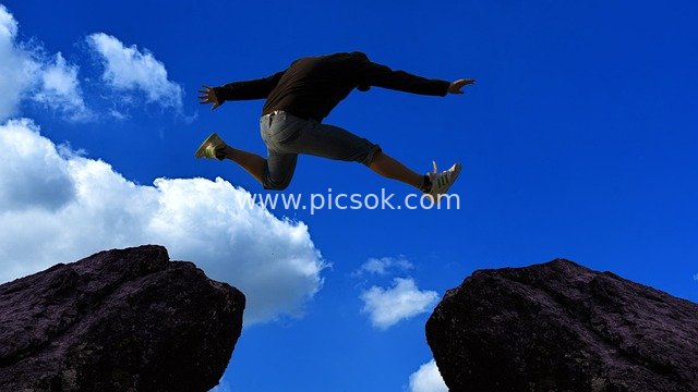 Figure Leaping Over Rocks: Courage and Hope Blossoming Against the Blue Sky