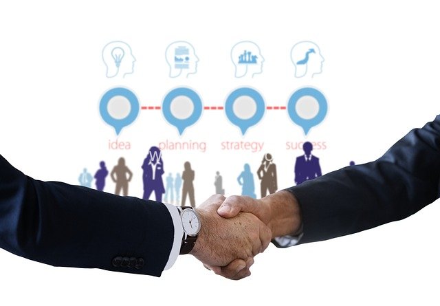 Business Professionals Shaking Hands: Team Collaboration & Win-Win Workplace Scenario
