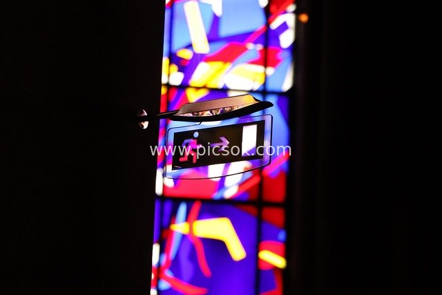 Exit Sign with Stained Glass Background in a Church