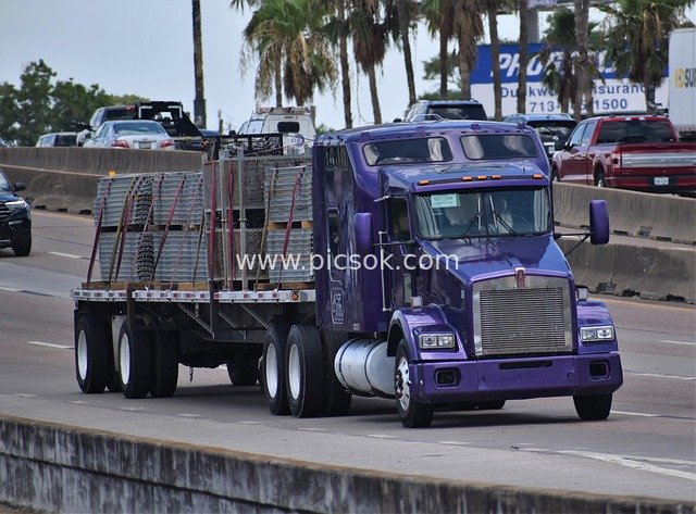 Real Shot of a Purple 18-Wheeler Truck Transporting Goods on the Highway