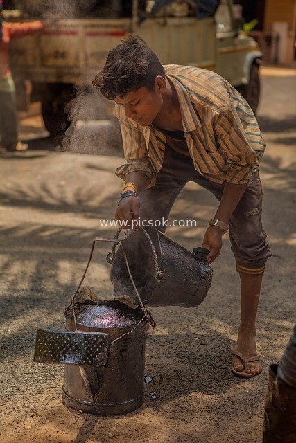 Indian Construction Worker Working Outdoors: Real Shot of Asphalt Construction Scene