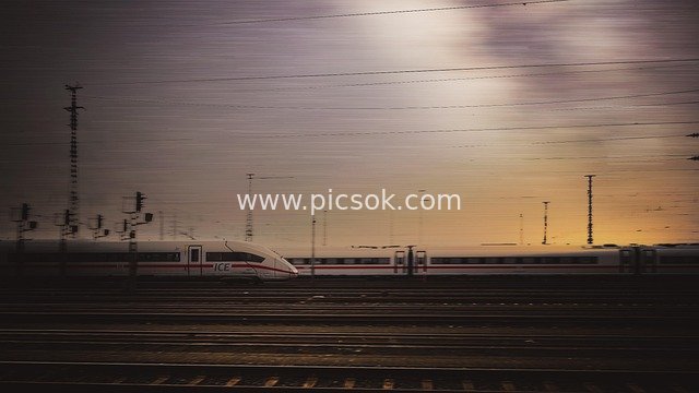 ICE High-Speed Train Speeding on Railway at Dusk
