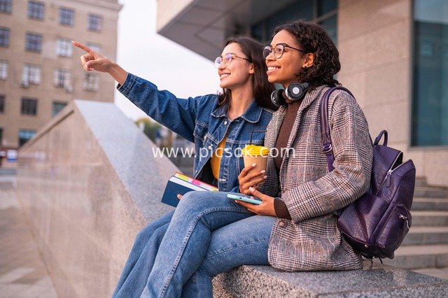 Two Female College Students Interacting Outdoors in an Urban Campus Setting