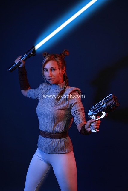 Star Wars Cosplay: Female Warrior with Lightsaber and Blaster Pose