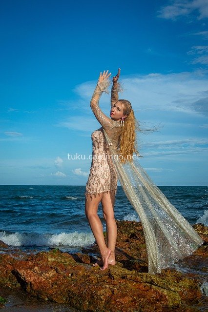 Fashion Portrait of Venezuelan Model in Sequin Dress on Seaside Rocks