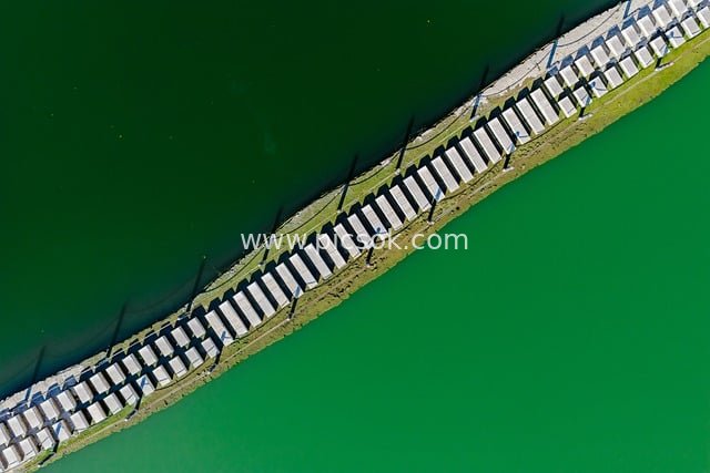 航拍绿色湿地堤岸 水域建筑结构景观