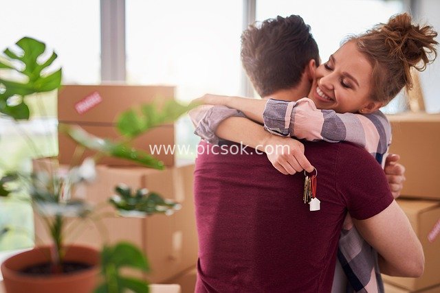 Couple Hugging to Celebrate Moving into a New Home – Keys Witness Their Happy Moment in the New Residence