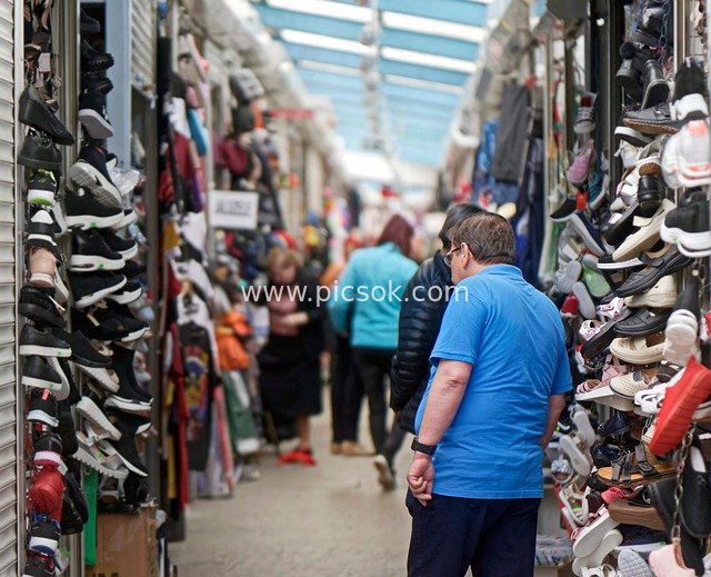 Shoppers at a Market Shoe Stall: Abundant Goods and Vibrant Atmosphere