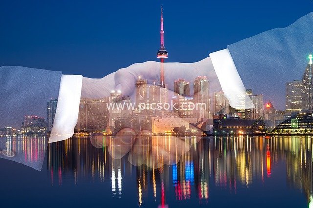 Cooperative Imagery: Business Handshake Merged with Urban Night Skyline