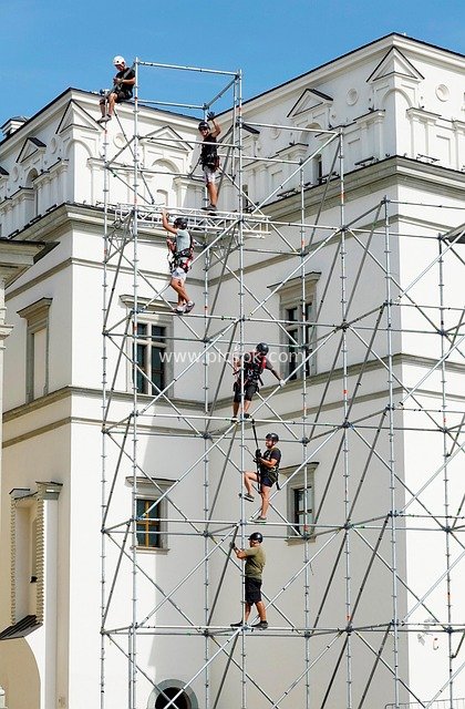 Working Scene of Scaffolding Installation Workers in a Summer City