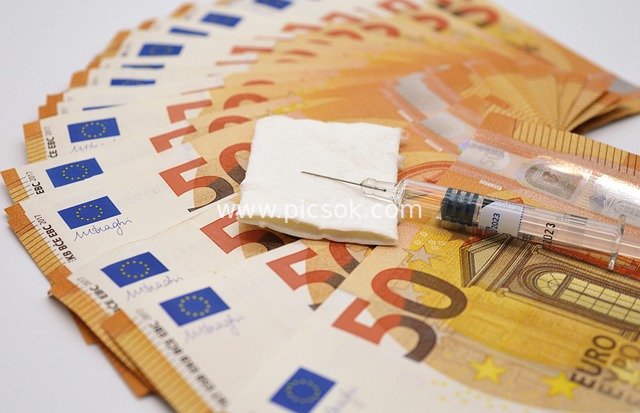 Medical Expenses and Vaccine Costs: Syringe on 50-Euro Banknotes