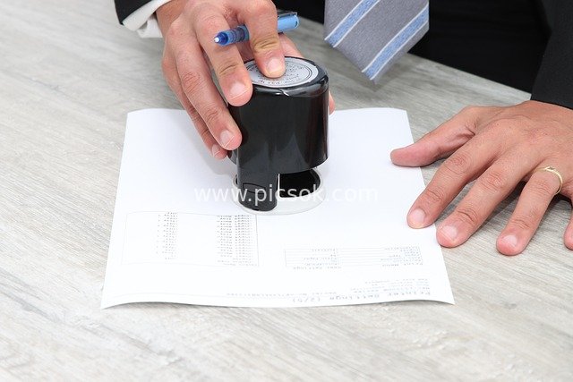 Business Professional Stamping & Signing Documents – Real Office Scene