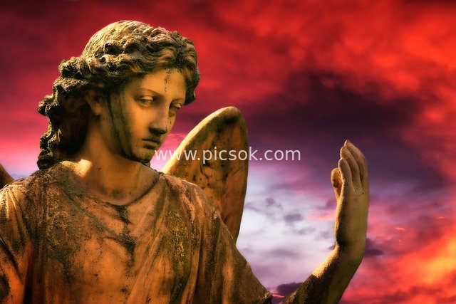 Angel Sculpture Under the Red Sky: A Sacred Image Guarding Hope