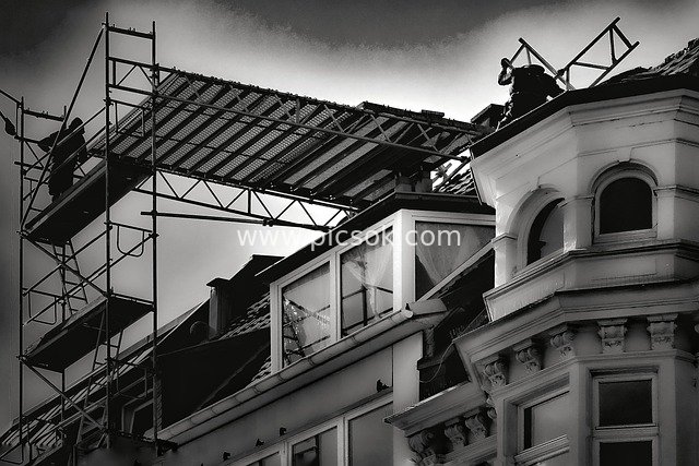 Black-and-White Construction Scene: Craftsmen Working on Scaffolding