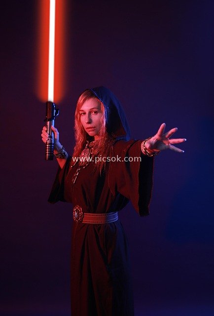 Star Wars Sith Cosplay Portrait of Female Warrior with Red Glowing Lightsaber
