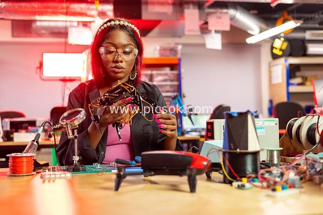 Female Engineer Focused on R&D Operating Electronic Equipment in the Lab