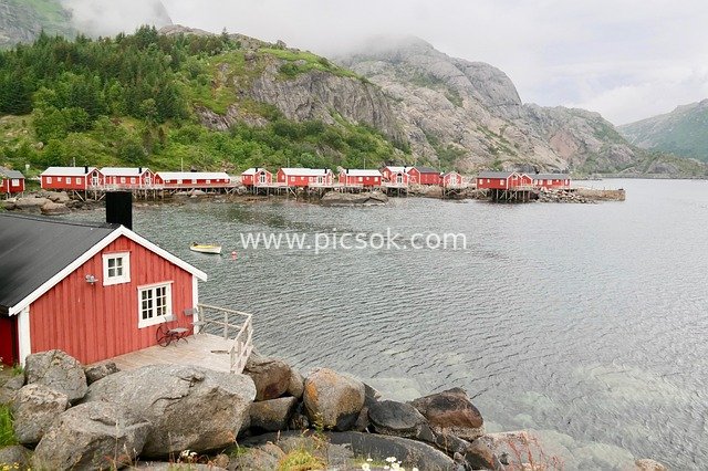 Scenic View of Red Wooden Cabins in Lofoten Coastal Fishing Village, Norway