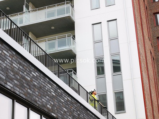 Construction Worker Inspecting Details of Modern Building Construction