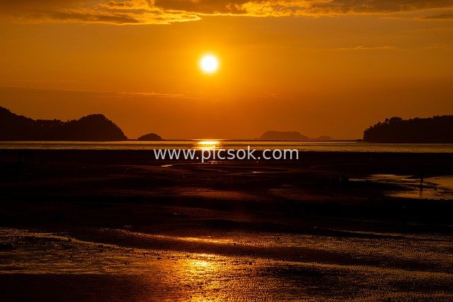 Romantic Sunset at Golden Coast: A Meeting of Sandy Beach, Ocean and Evening Glow