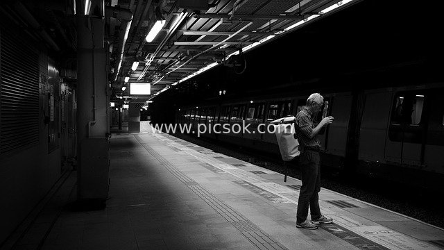 Black-and-White Image: A Man Waiting Alone on a Hong Kong MTR Platform