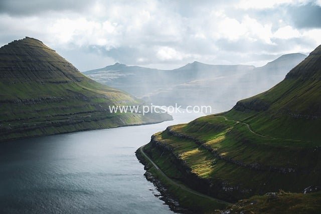 Faroe Islands Fjord Landscape: A Natural Canvas of Sunlit Mountains and Turquoise Waters